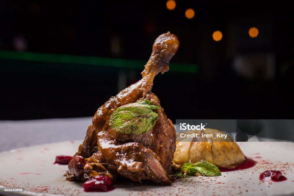 Duck leg with fruit. A tasty dish in the restaurant. A tasty dish in the restaurant Gourmet Stock Photo