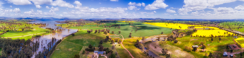 Developed agricultural farms with cultivated fields of crops and canola around Hume lake, Murray river area of NSW near Albury.