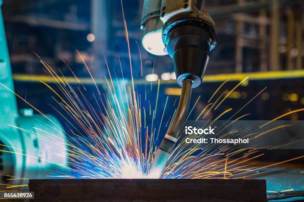 Industrial Robot Is Welding In Automotive Part Factory Stock Photo - Download Image Now