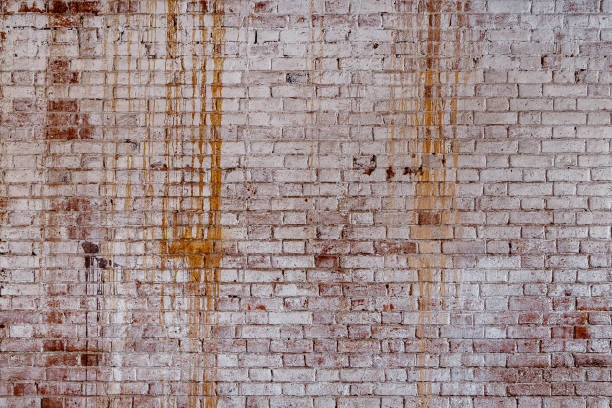 istock Background of old vintage dirty brick wall with peeling plaster 865639334