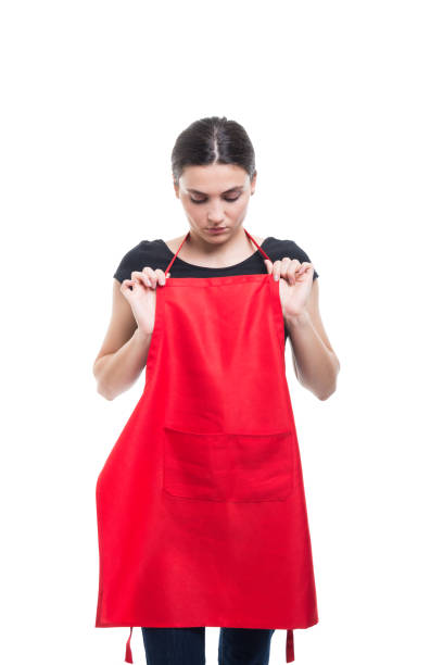 Female merchandiser adjusting her new apron Female merchandiser or assistant adjusting her new apron received from work isolated on white background merchandiser stock pictures, royalty-free photos & images