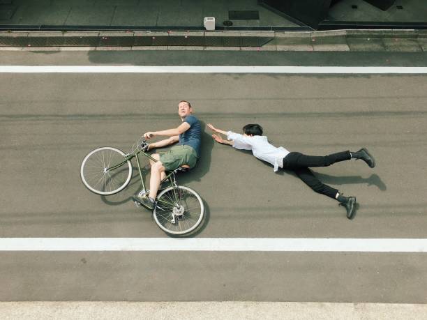 Woman and Man on bicycle lying on the floor