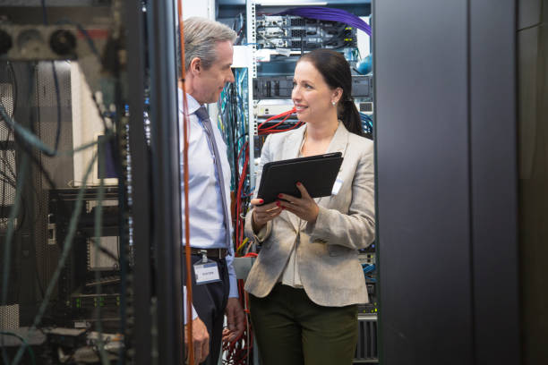 istock IT professionals having meeting in server room 865655966