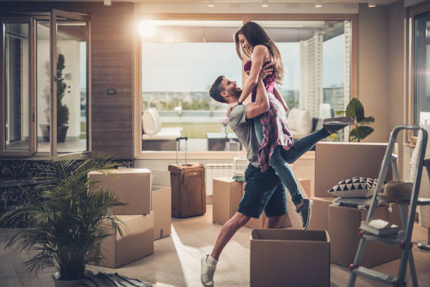 istock Playful couple having fun while moving into new apartment. 865656554