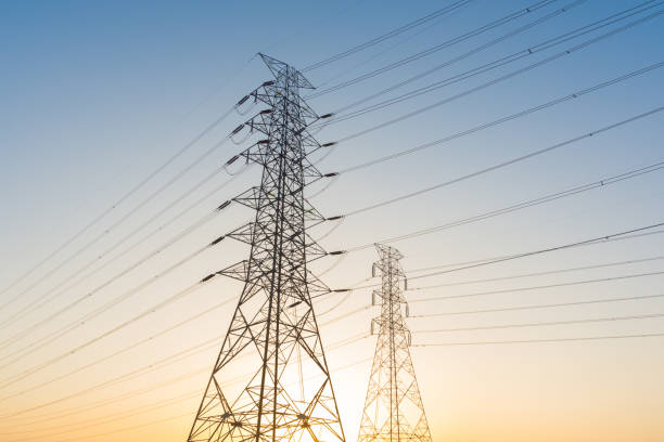 istock Electricity station. Close up high voltage power lines at sunset. 865658978