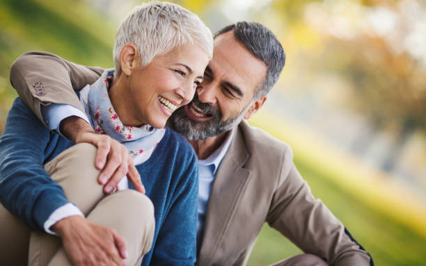istock Mid aged couple in a park 865660404