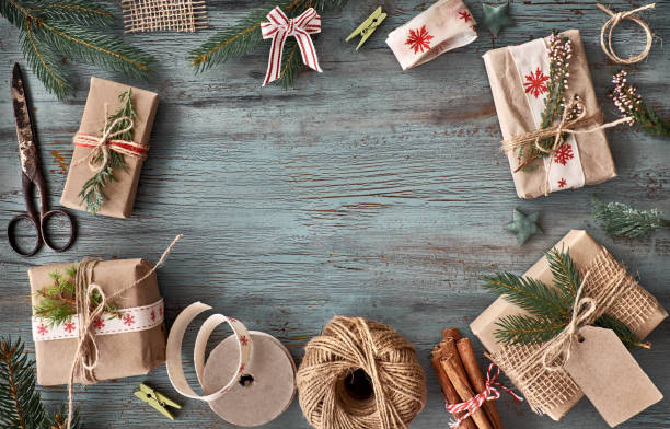 istock Hand crafted gifts on dark rustic wooden table with Christmas decorations 865660904