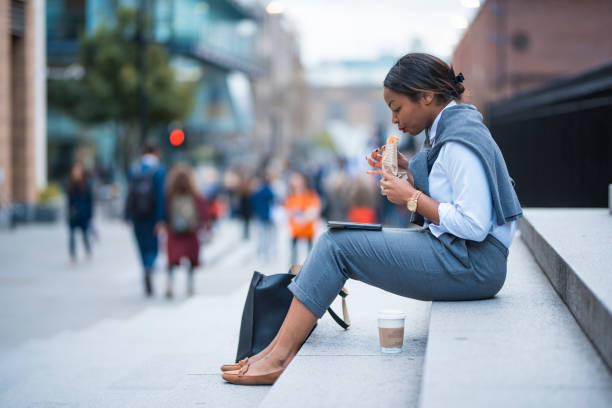 Businesswoman working and eating sandwich