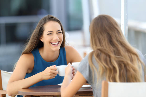 istock Two happy friends talking in a restaurant terrace 865675878
