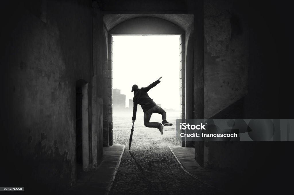 happy man jumping happy despite the bad weather Black And White Stock Photo