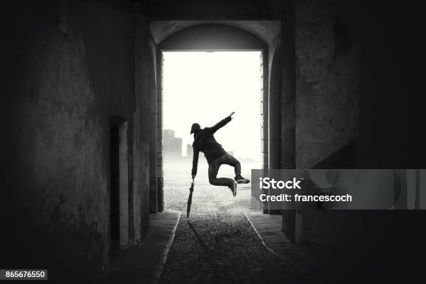 Happy Man Jumping Happy Despite The Bad Weather Stock Photo - Download Image Now - Black And White, Dancing, Photography