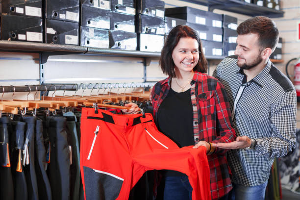 istock Couple choosing touristic trousers 865679962