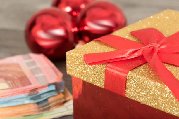 istock Euro banknotes, Christmas baubles and a gift 865680152