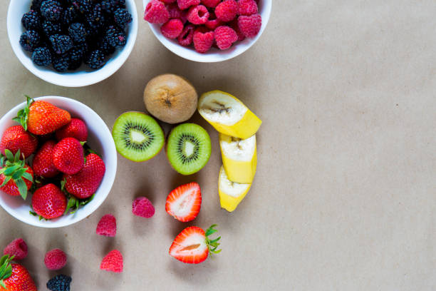 istock Small white bowls filled with ripe berries. 865680398