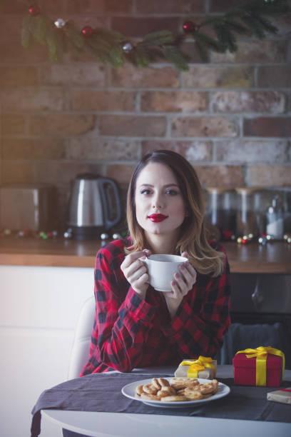 istock woman sitting and at kitchen with present gifts 865683780