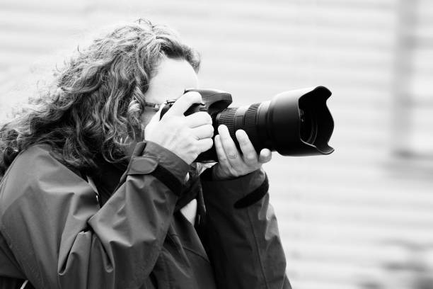 People photographer photography camera lens focusing woman outdoors street city People photographer photography camera lens focusing woman outdoors street city sports photography stock pictures, royalty-free photos & images