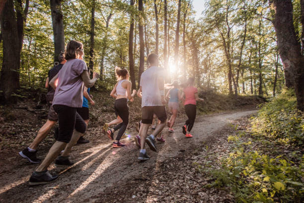 istock Rear view of athletes running a marathon through nature. 865684942