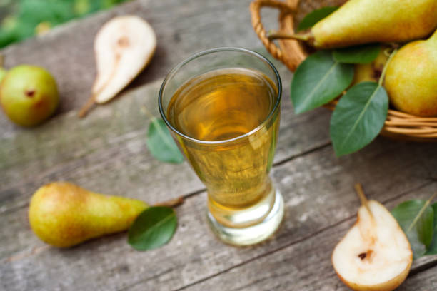 istock Fresh pear juice in glass on table 865692916