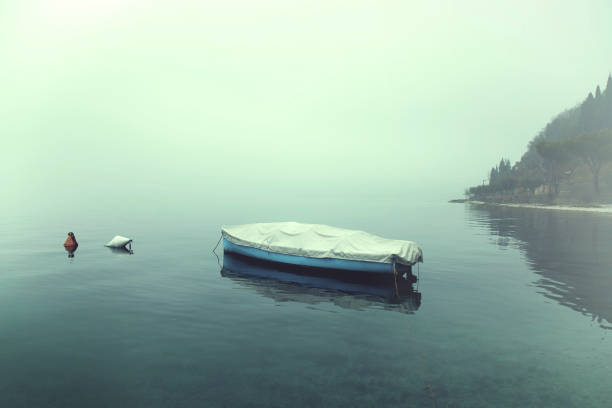 istock covered boat floating in the calm water in winter 865696030