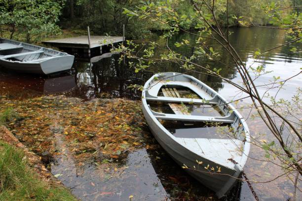 istock Two abandoned boats and jetty 865696368