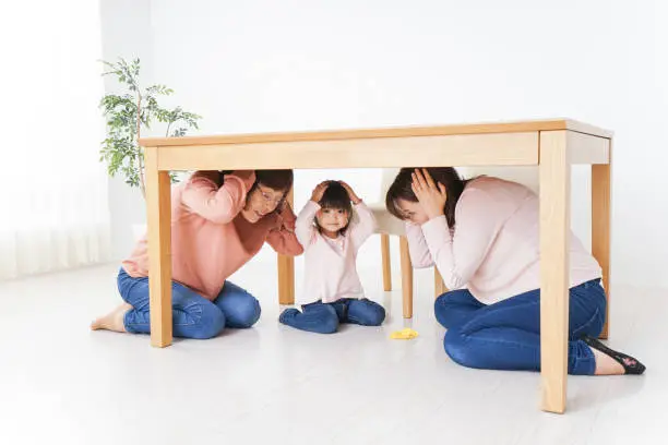 Photo of Family taking shelter under the desk