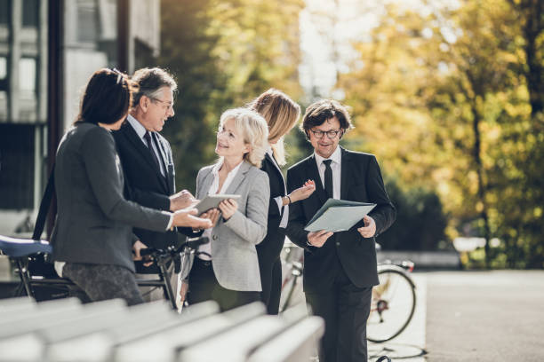 istock Business People Discussing in Front of Building 865700640