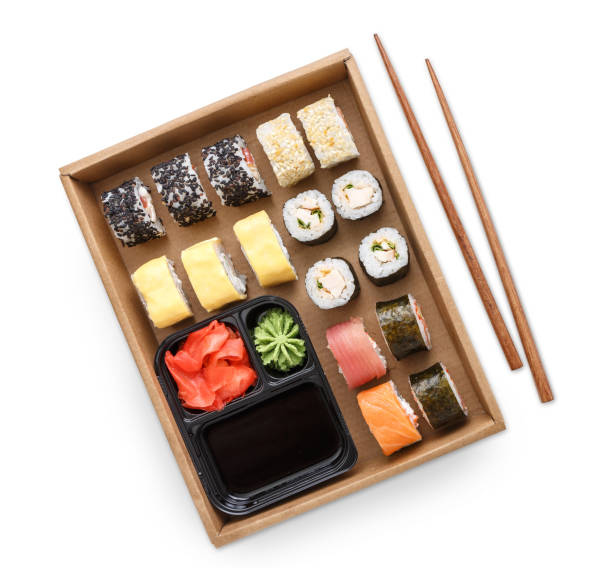 istock Top view set of sushi maki and rolls with chopstics, rice, soy and ginger isolated 865701708