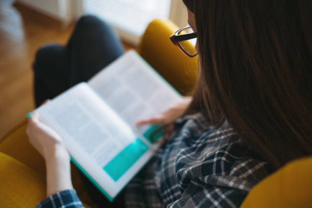 istock Young woman reading the book 865701918