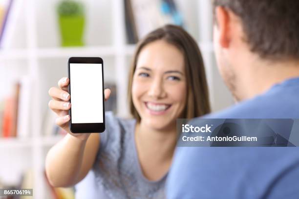 Woman Showing Phone Screen To A Friend Stock Photo - Download Image Now - Showing, Couple - Relationship, Mobile Phone