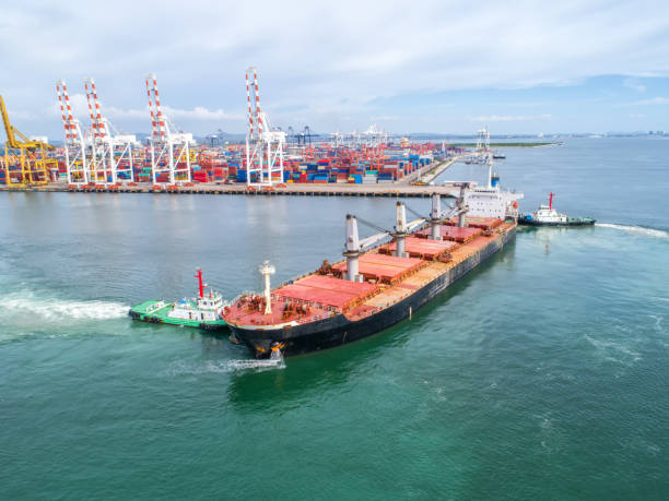istock container,container ship in import export and business logistic,By crane,Trade Port , Shipping,cargo to harbor.Aerial view,Water transport,International,Shell Marine,transportation,logistic,trade,port 865708814