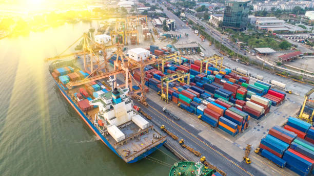 istock container,container ship in import export and business logistic,By crane,Trade Port , Shipping,cargo to harbor.Aerial view,Water transport,International,Shell Marine,transportation,logistic,trade,port 865708840