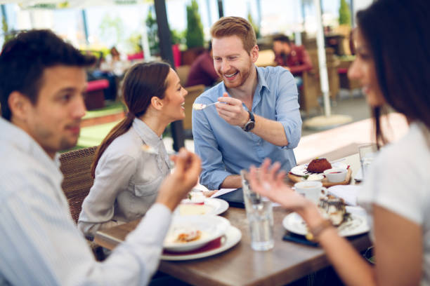 istock Young affectionate business couple sharing a desert in cafe 865709866