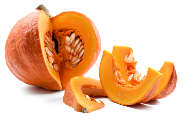 istock Organic ripe bright orange pumpkin cut with seeds isolated on white background 865710646