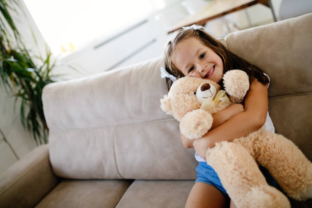 istock Cute little girl playing with teddy bear 865713654