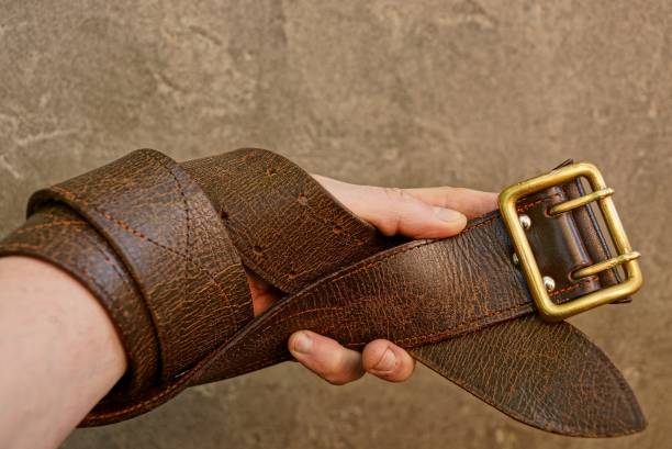 istock Brown strap wound on the hand against the gray concrete wall 865714198
