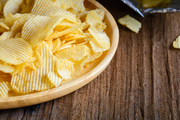 istock Snacks in a wooden dish on a table 865714348