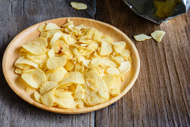 istock Snacks in a wooden dish on a table 865714394