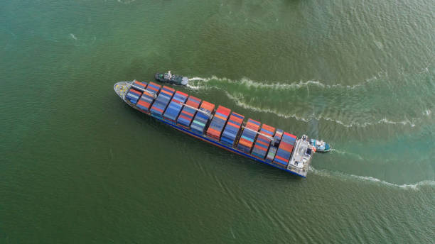 istock container,container ship in import export and business logistic,By crane,Trade Port , Shipping,cargo to harbor.Aerial view,Water transport,International,Shell Marine,transportation,logistic,trade,port 865719366