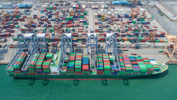 istock container,container ship in import export and business logistic,By crane,Trade Port , Shipping,cargo to harbor.Aerial view,Water transport,International,Shell Marine,transportation,logistic,trade,port 865719520