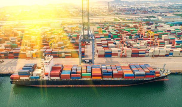 istock container,container ship in import export and business logistic,By crane,Trade Port , Shipping,cargo to harbor.Aerial view,Water transport,International,Shell Marine,transportation,logistic,trade,port 865719538