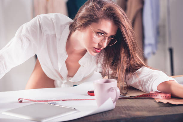 istock Fashion designers working in studio sitting on the desk 865721994