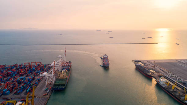istock container,container ship in import export and business logistic,By crane,Trade Port , Shipping,cargo to harbor.Aerial view,Water transport,International,Shell Marine,transportation,logistic,trade,port 865722150