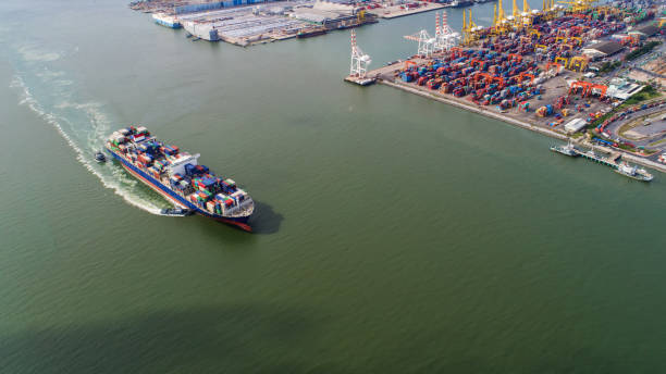 istock container,container ship in import export and business logistic,By crane,Trade Port , Shipping,cargo to harbor.Aerial view,Water transport,International,Shell Marine,transportation,logistic,trade,port 865723516