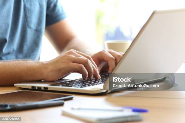 Man Hands Typing On A Laptop Keyboard On A Desk Stock Photo - Download Image Now - Hand, Computer, Men