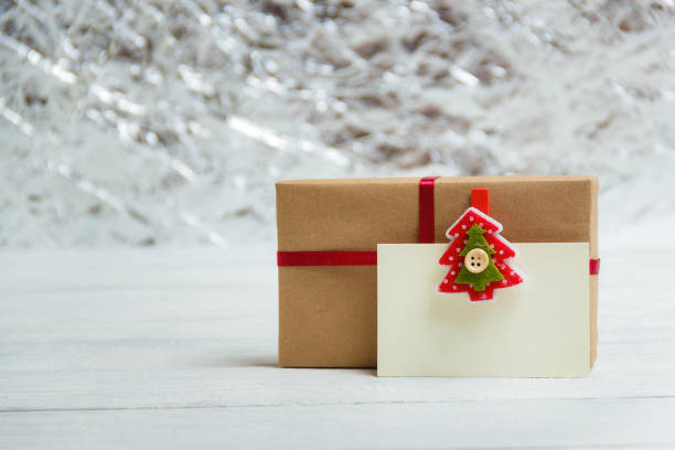 istock Vintage gift box package with blank gift tag on white wooden background 865728096