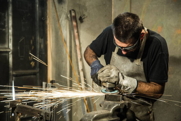istock Small business owner grinding at his garage 865728316