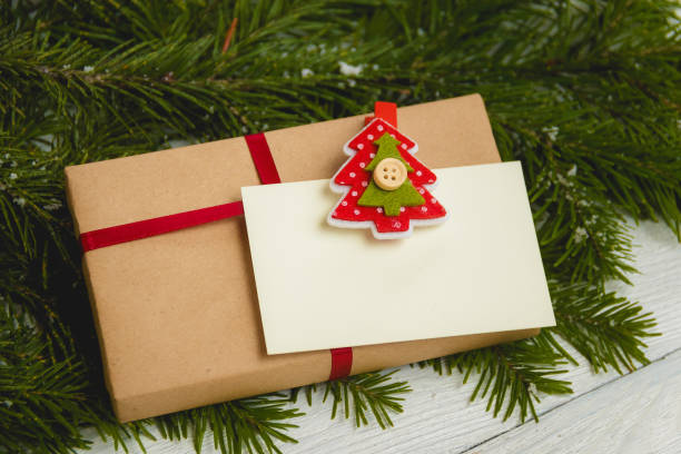 istock Christmas gift or present box wrapped in kraft paper on christmas decoration 865729384