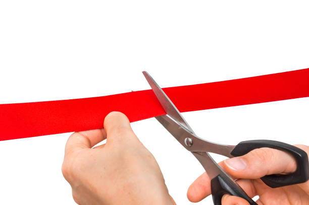 istock Hand with scissors cutting red ribbon - opening ceremony 865729588