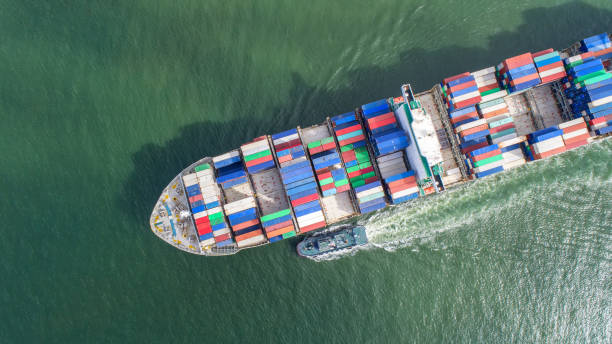 istock container,container ship in import export and business logistic,By crane,Trade Port , Shipping,cargo to harbor.Aerial view,Water transport,International,Shell Marine,transportation,logistic,trade,port 865729652