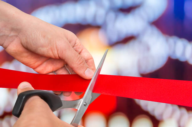 istock Hand with scissors cutting red ribbon - opening ceremony 865732238
